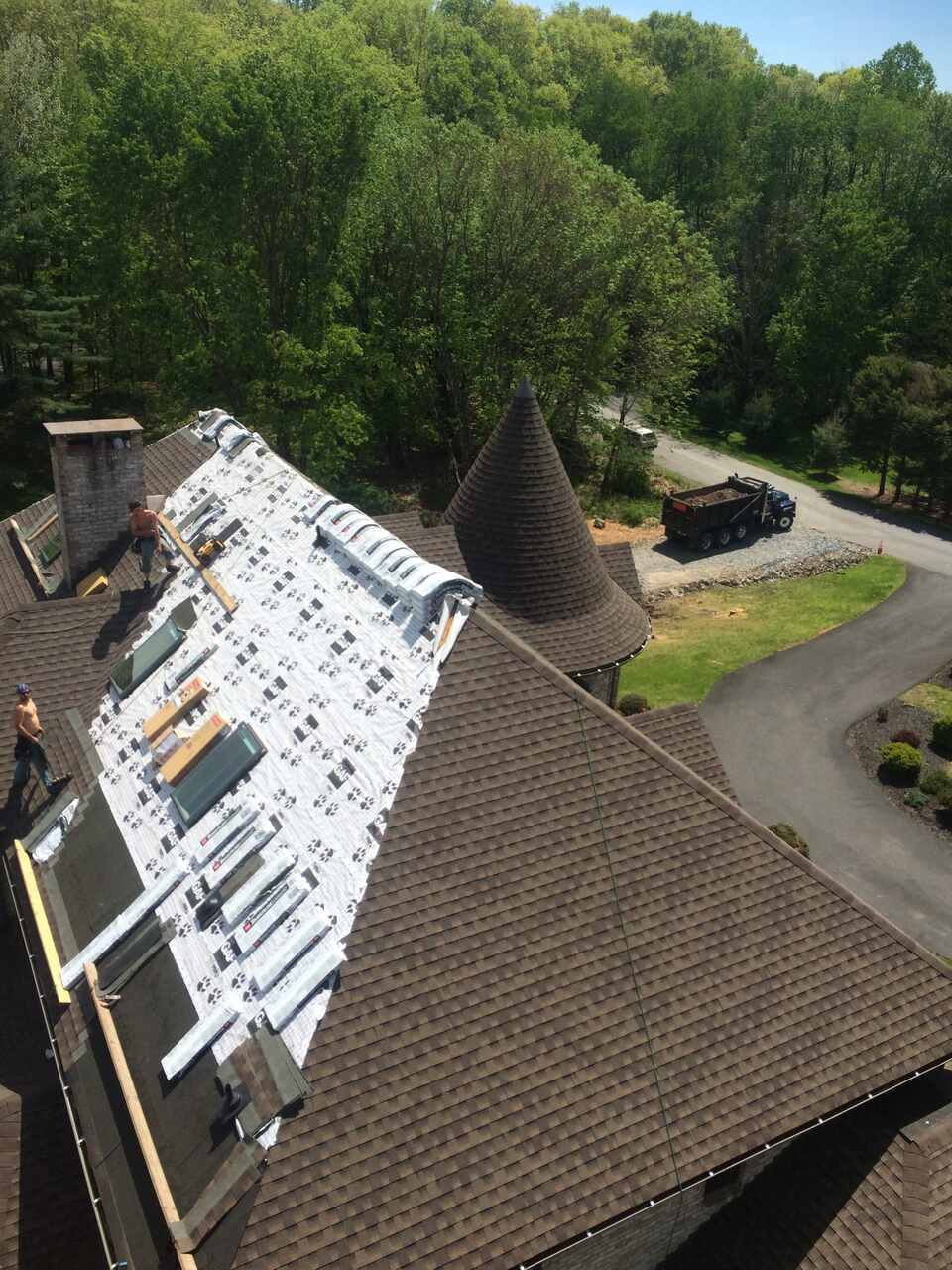 Workers replacing residential roof